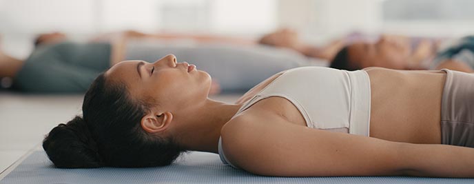 Young girl lying down and meditating