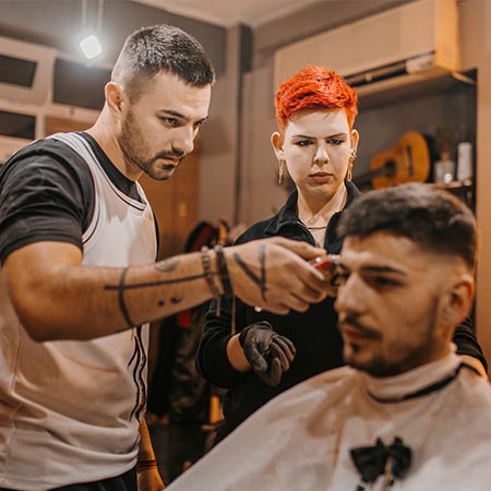 Apprentice barber watching shaving