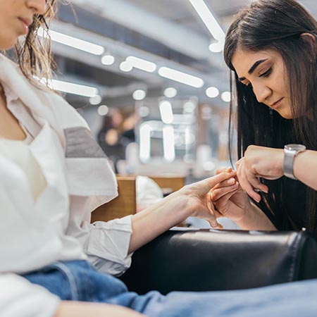 Apprentice cutting clients' nails