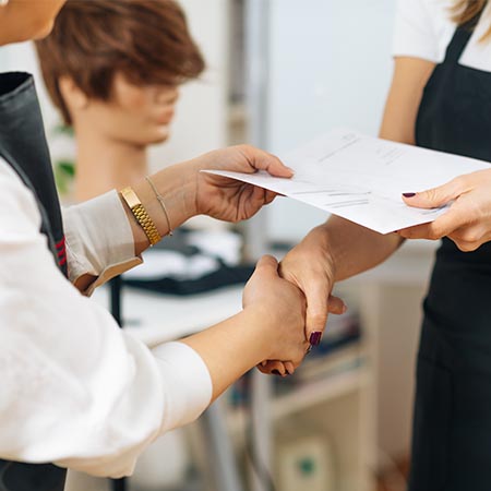 Hairdressing apprentice receiving qualification