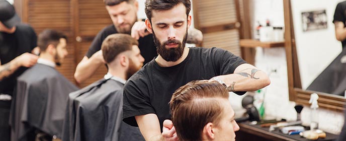 Barbers working in barbershop