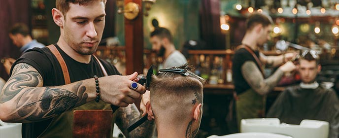 Barbers working in barbershop