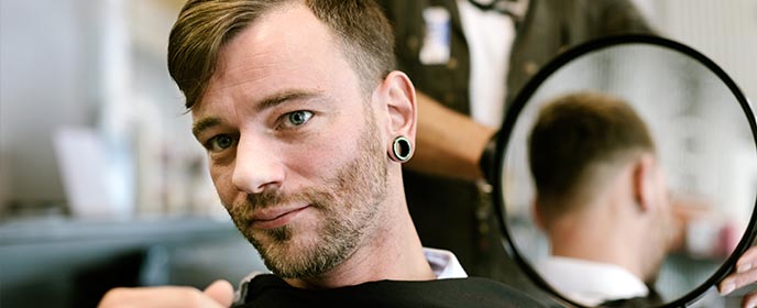 Barber showing off cut in mirror