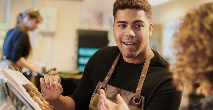 Barber smiling, highlighting workplace policy issu