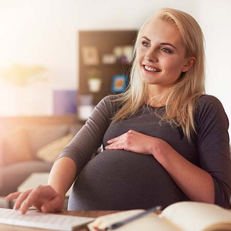 Lady touching her pregnancy bump