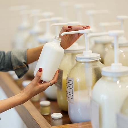 Lady re-filling jars